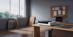 Bambu Lab R1 CO2 laser cutter with laser-cut wood and acrylic projects